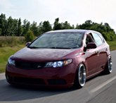 Spicy Red Kia Forte 5 With C-Mod grille, Rear Camber Shims